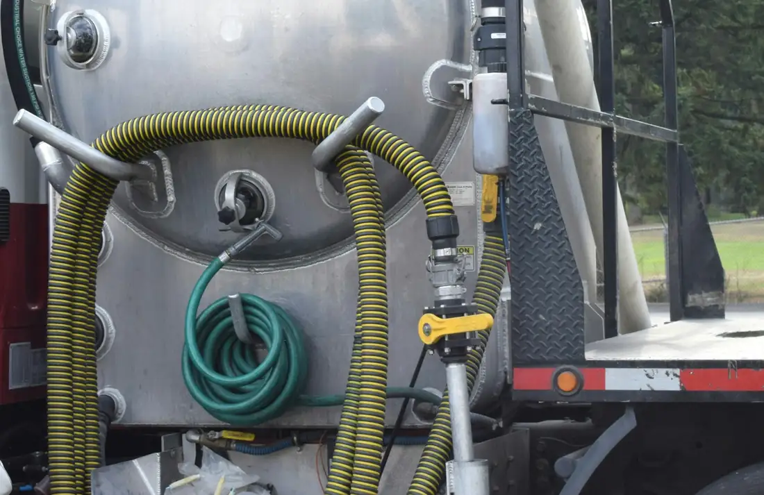 Hoses and fittings on a vacuum tank truck.